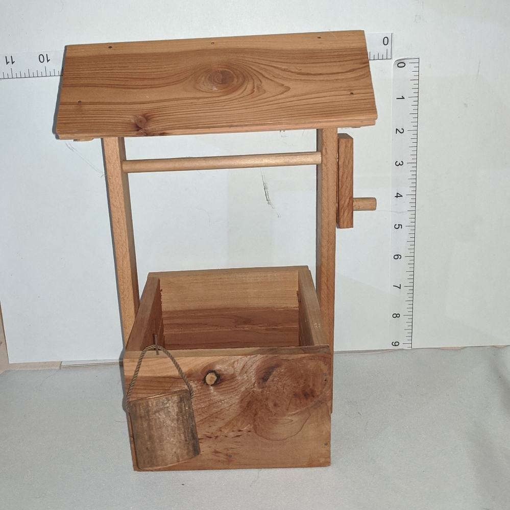 Wood wishing well with bucket